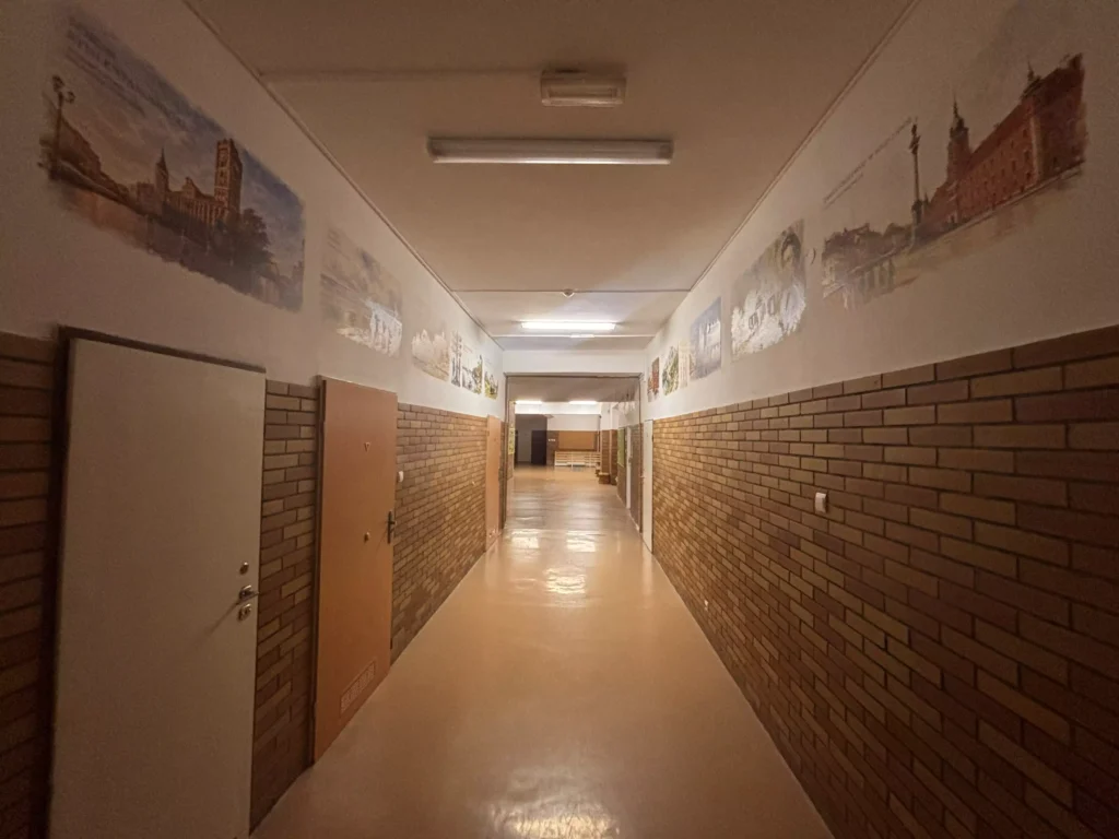 Korytarz szkolny z grafikami edukacyjnymi wykonanymi techniką druku ściennego - realizacja w Ozimku
